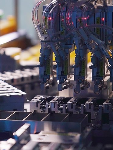 Close-up of automated manufacturing process with robotic arms and precision machinery